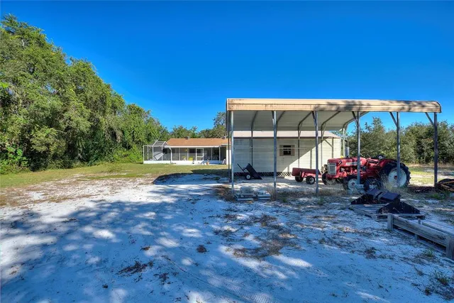 a living room with furniture and floor to ceiling windows