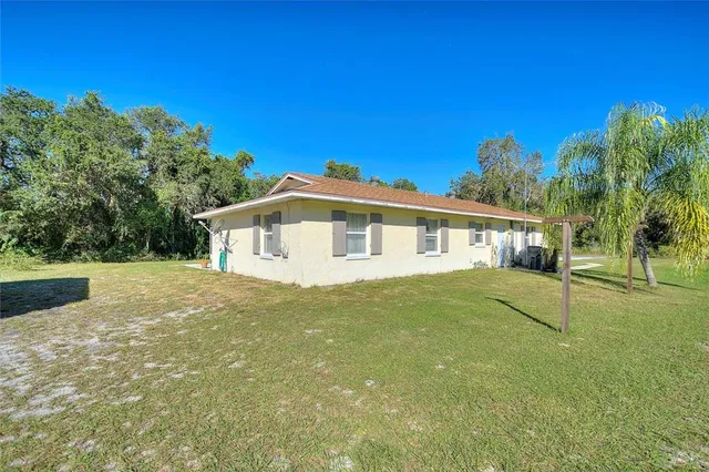 a view of a lake with a house in a yard