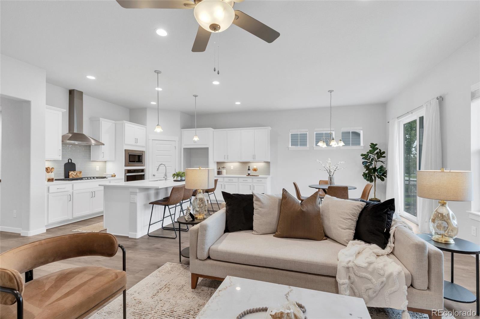 a living room with furniture and kitchen view