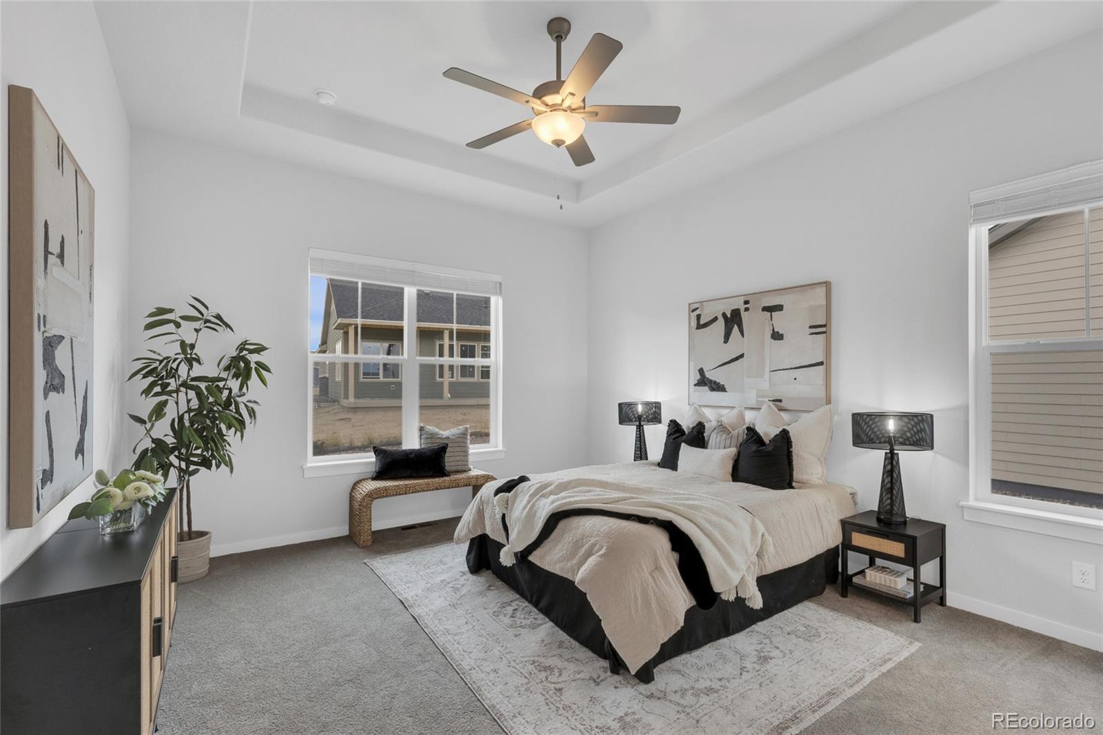 8878 South Riviera Court Aurora, CO 80016 - Photo 15 of 31 a bedroom with a bed and a potted plant