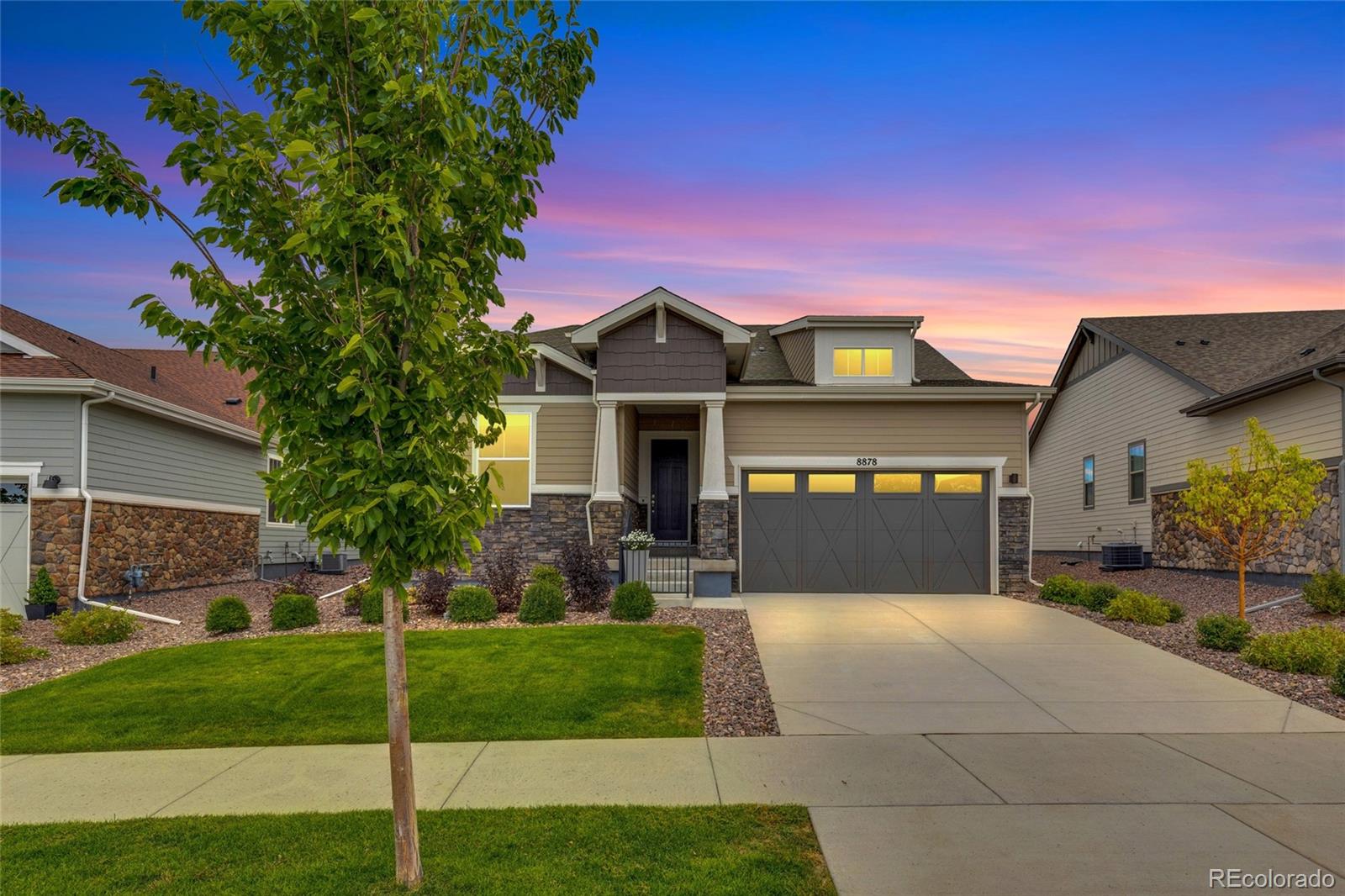 8878 South Riviera Court Aurora, CO 80016 - Photo 2 of 31 a front view of a house with yard and green space