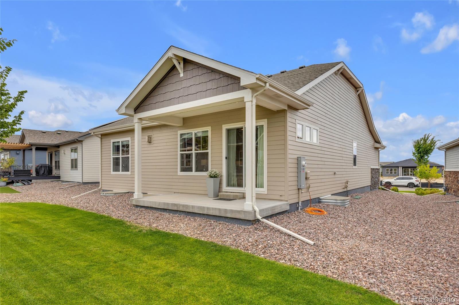 8878 South Riviera Court Aurora, CO 80016 - Photo 26 of 31 a view of a house with a yard and sitting area