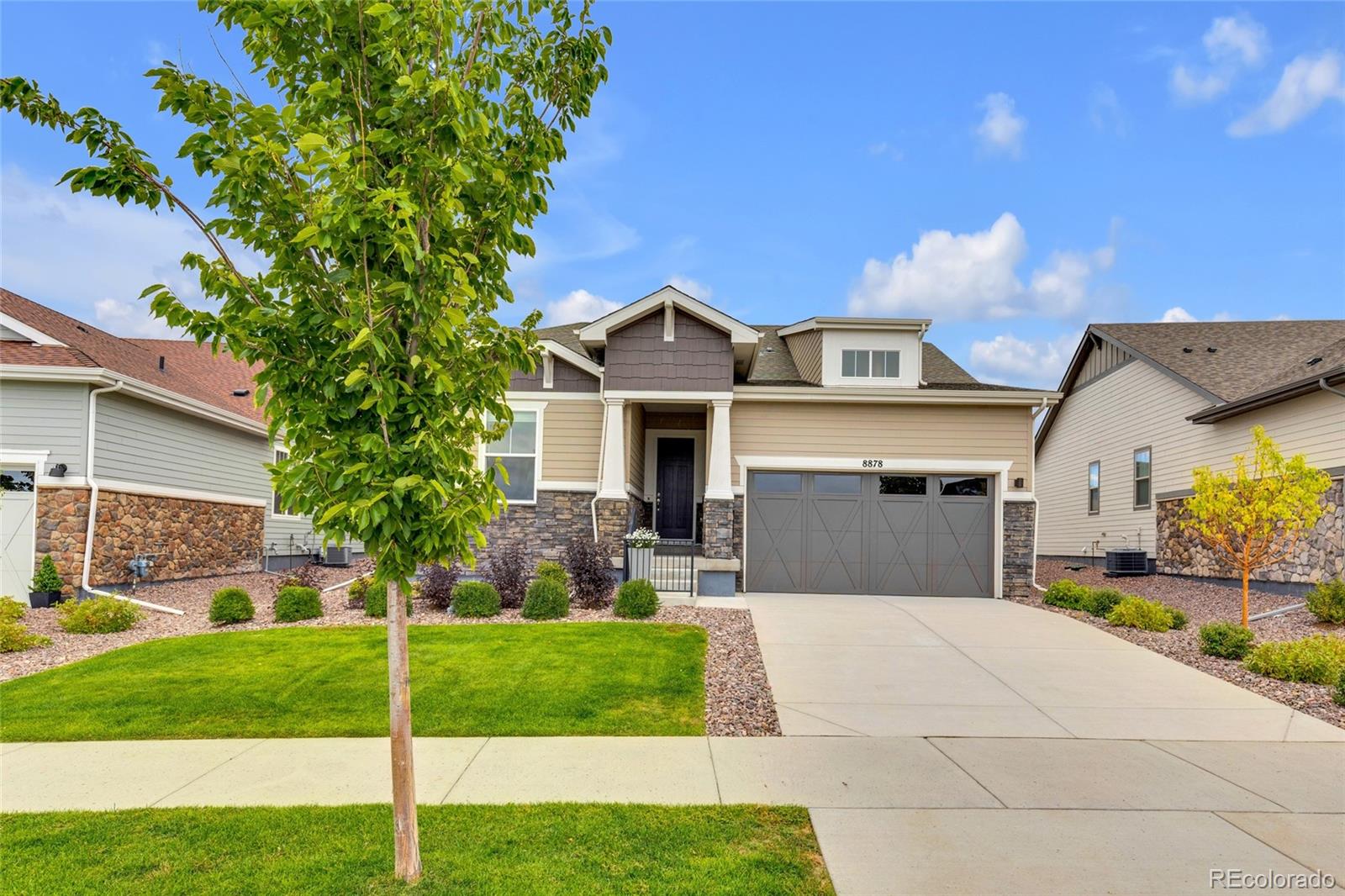 8878 South Riviera Court Aurora, CO 80016 - Photo 28 of 31 a front view of a house with a yard