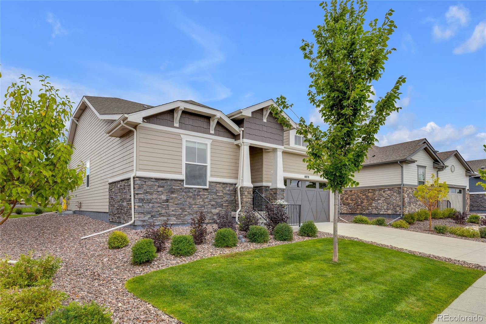 8878 South Riviera Court Aurora, CO 80016 - Photo 3 of 31 a front view of a house with a yard