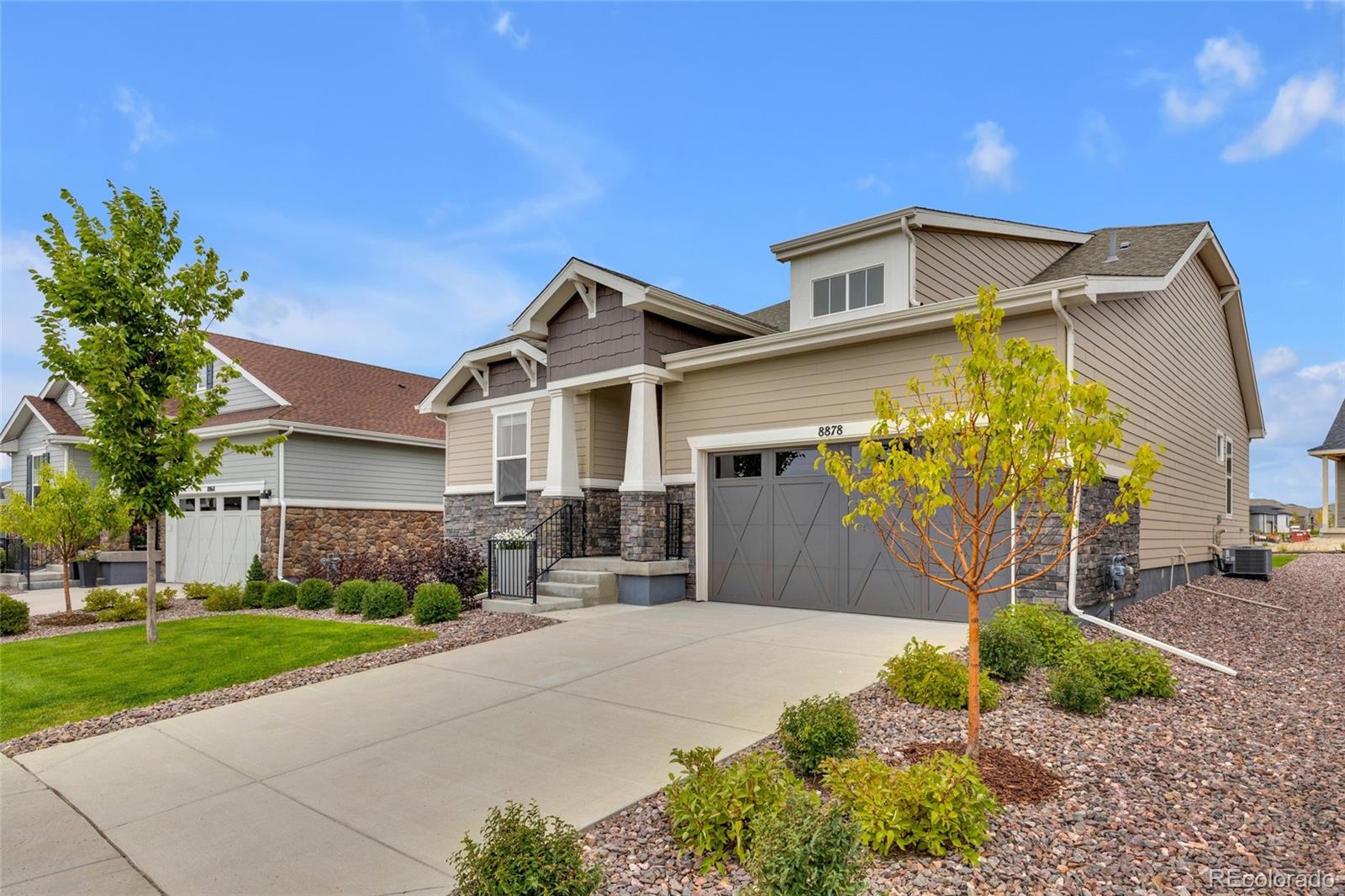 8878 South Riviera Court Aurora, CO 80016 - Photo 4 of 31 a front view of a house with garden