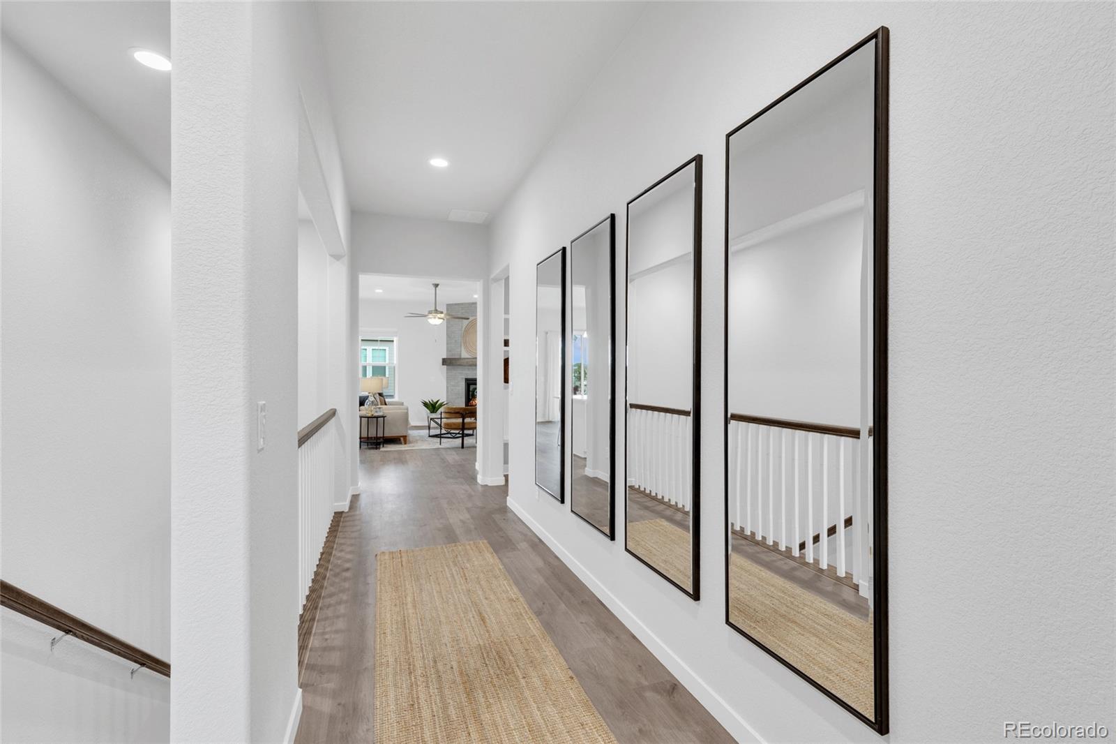 8878 South Riviera Court Aurora, CO 80016 - Photo 5 of 31 a view of a hallway with wooden floor and furniture