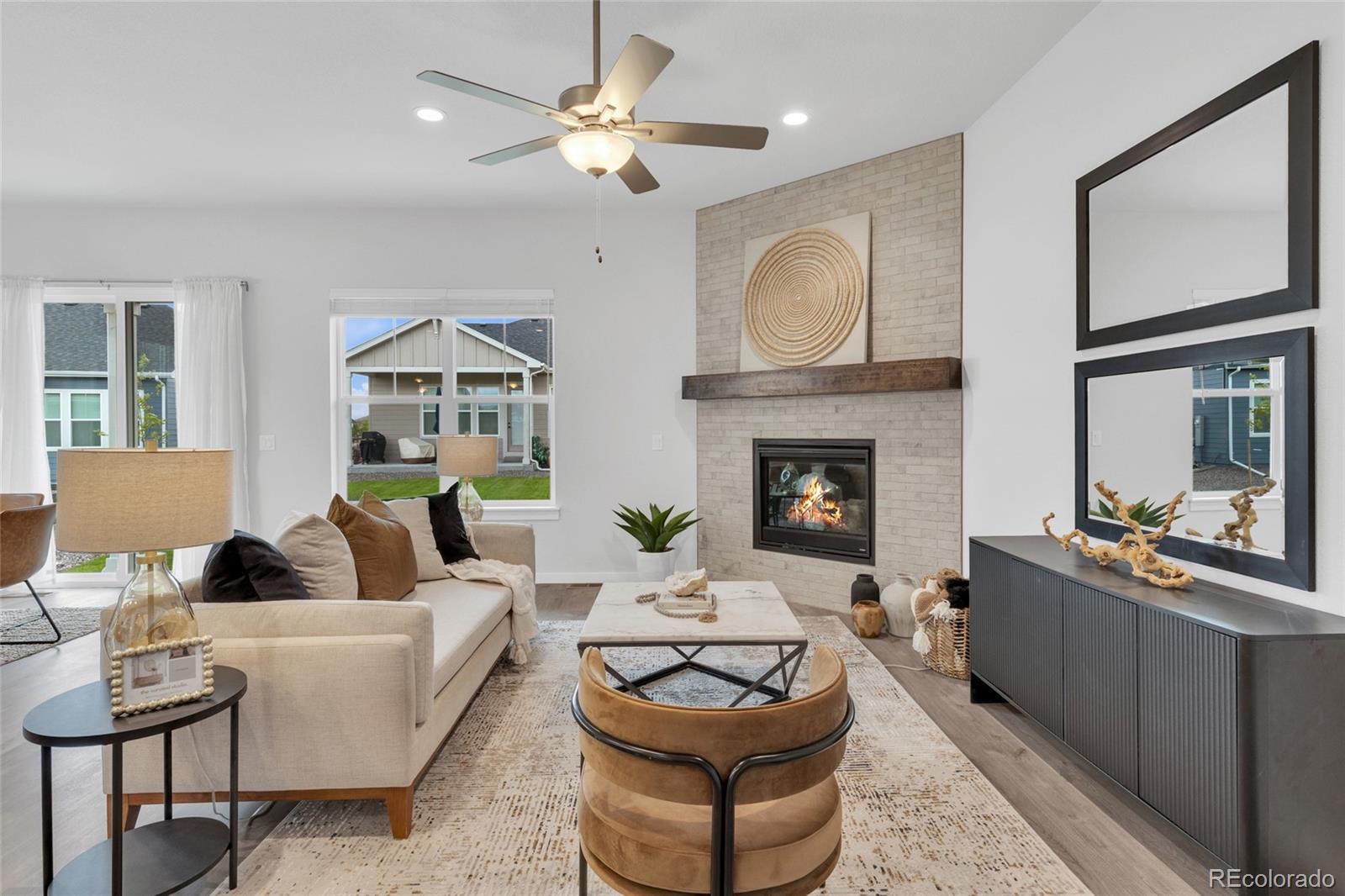8878 South Riviera Court Aurora, CO 80016 - Photo 6 of 31 a living room with furniture and a fireplace