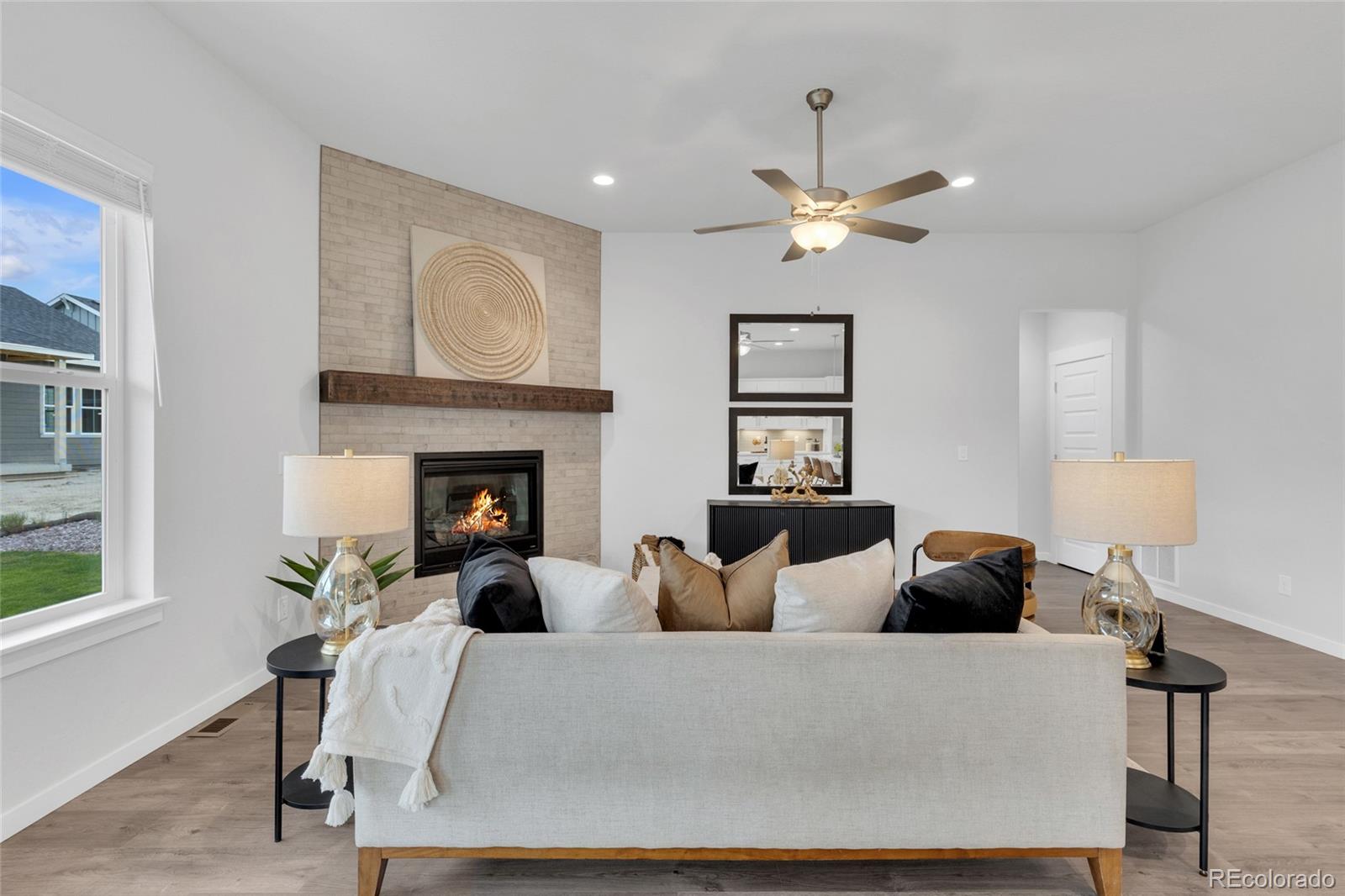8878 South Riviera Court Aurora, CO 80016 - Photo 8 of 31 a living room with furniture and a fireplace