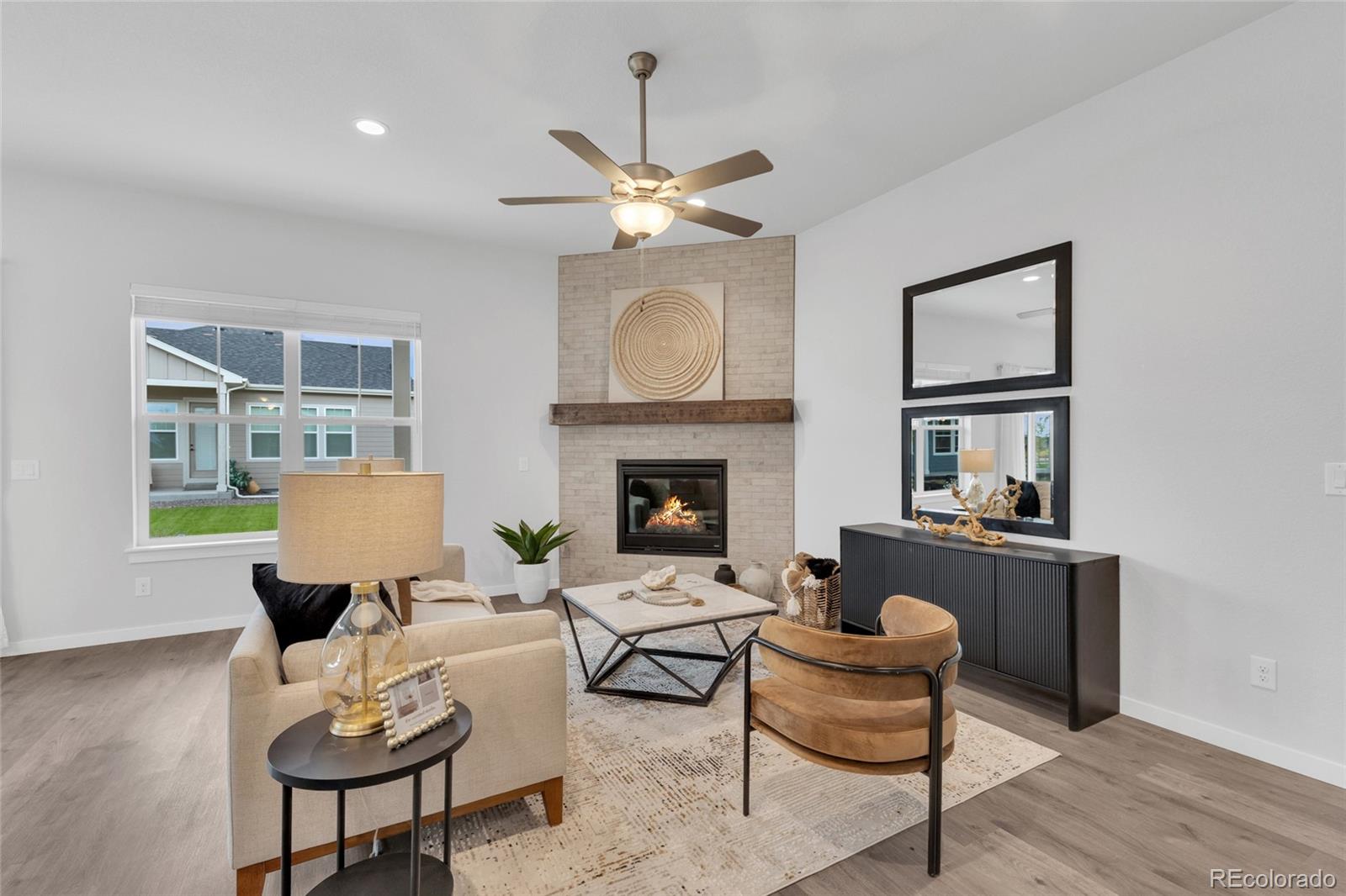 8878 South Riviera Court Aurora, CO 80016 - Photo 9 of 31 a living room with furniture and a fireplace