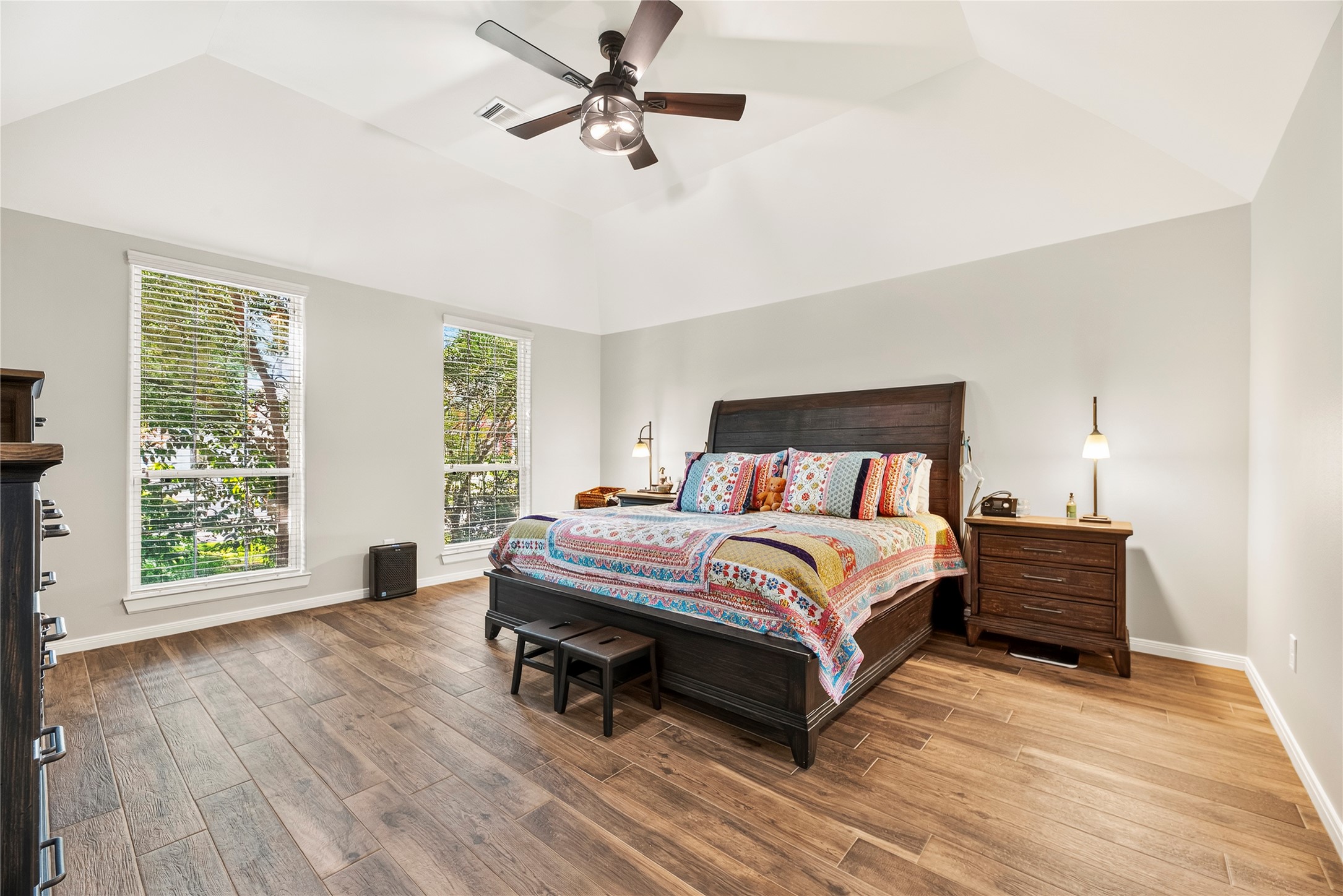 16222 Rainbow Lake Road Houston, TX 77095 - Photo 16 of 34 Large primary bedroom boasts a high ceiling, ceiling fan, wood-look tile flooring and an en-suite bathroom.