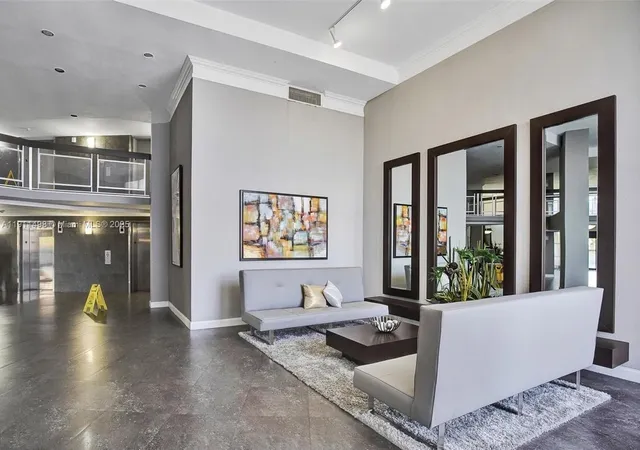 a living room with furniture and large windows