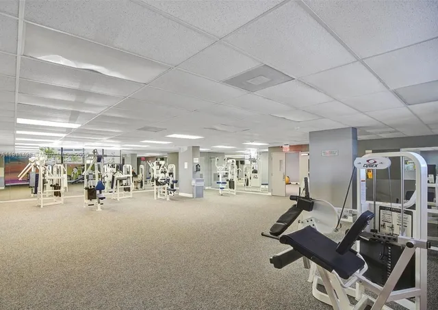 a living room with furniture pool table and windows