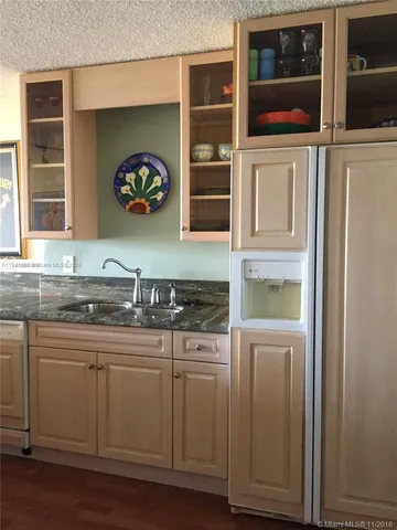 a kitchen with stainless steel appliances granite countertop a sink and a microwave