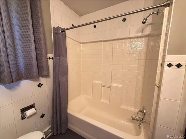 a bathroom with a shower and a tub