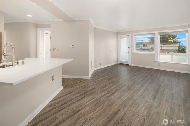 a view with cabinets wooden floor and a kitchen