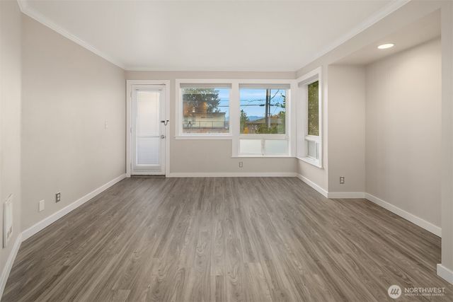 wooden floor in an empty room with a window