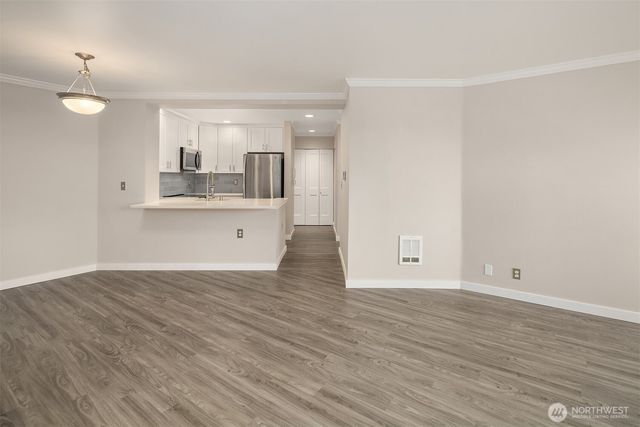 a view of kitchen with granite countertop cabinets and wooden floor