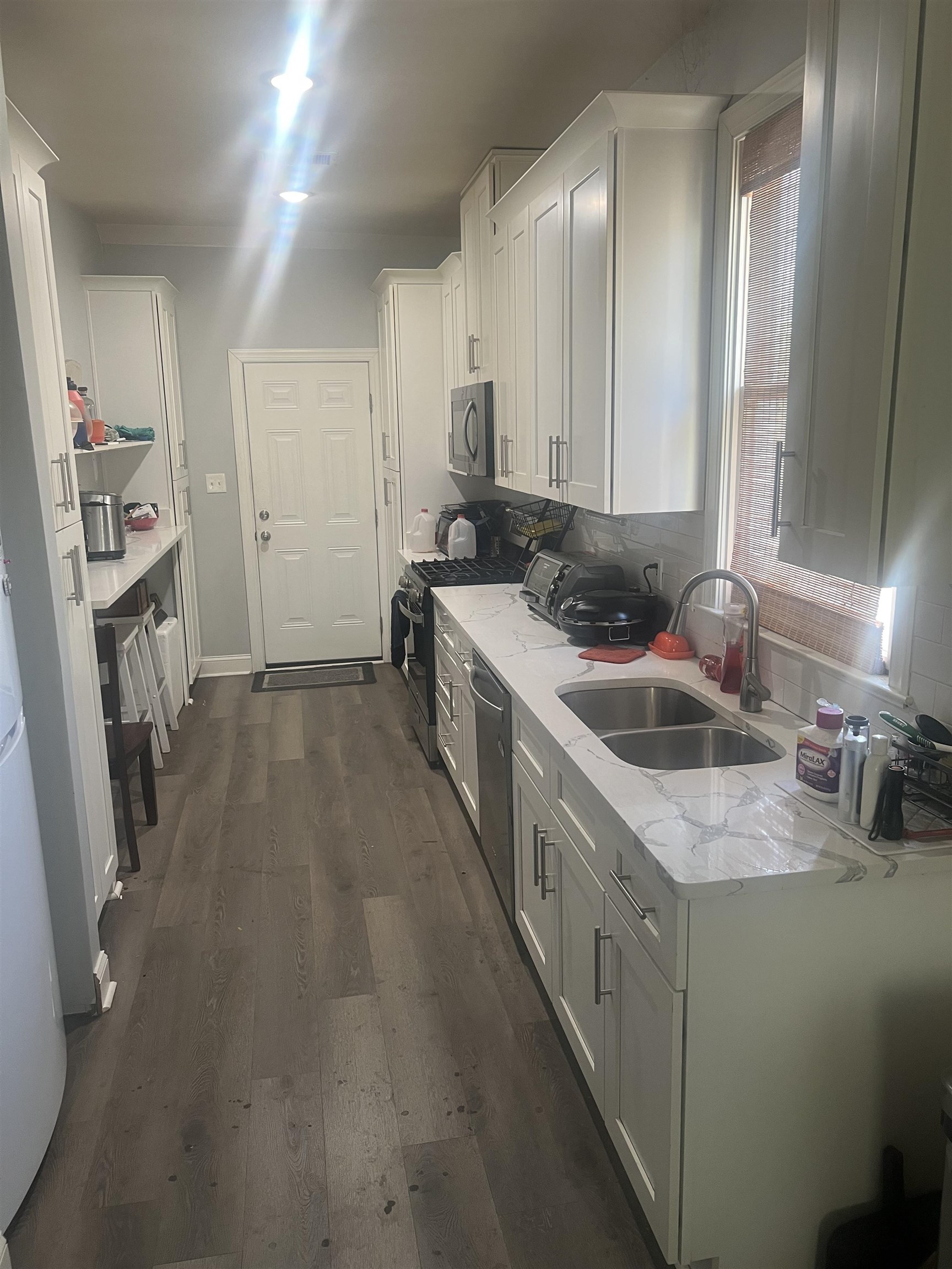 1353 Harbert Avenue Memphis, TN 38104 - Photo 3 of 18 a kitchen with a sink stove and cabinets