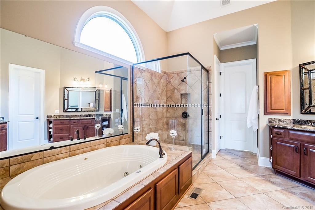 8116 Balcony Bridge Road Huntersville, NC 28078 - Photo 15 of 31 a spacious bathroom with a tub a double vanity sink a mirror and a shower