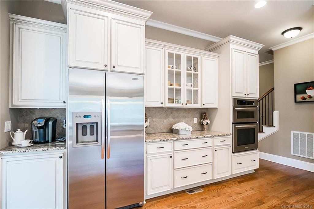 8116 Balcony Bridge Road Huntersville, NC 28078 - Photo 9 of 31 a kitchen with stainless steel appliances cabinets and a window