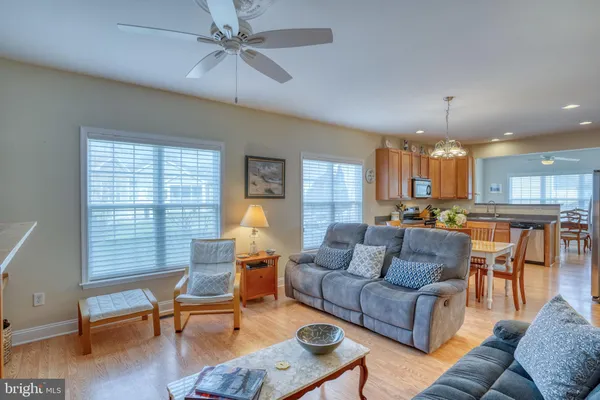a kitchen with stainless steel appliances granite countertop a stove top oven a sink a dining table and chairs