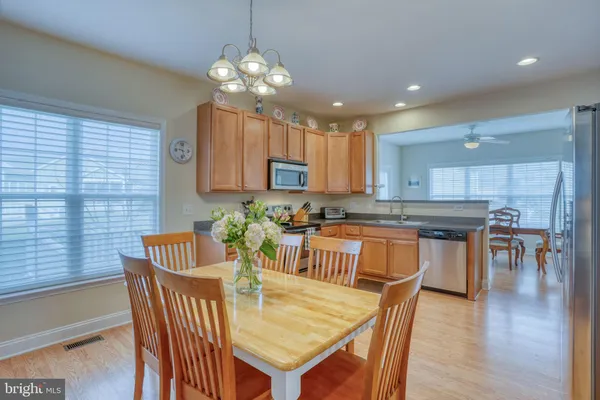 a kitchen with stainless steel appliances granite countertop a sink stove and microwave