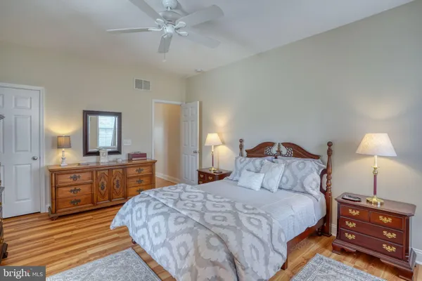a bedroom with a bed dresser and a window