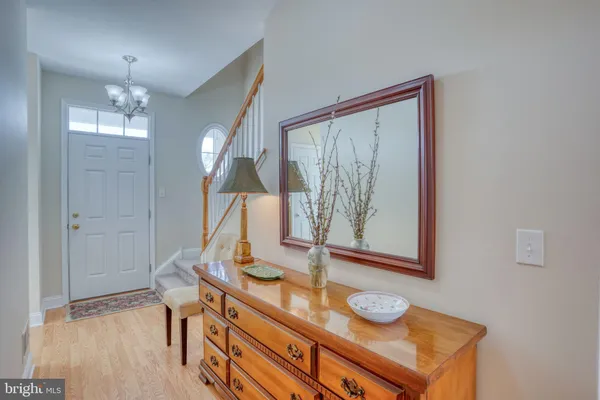a view of a hallway and dining room with wooden floor