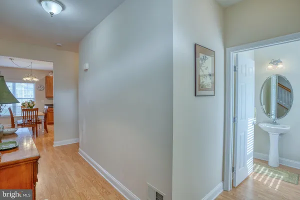 a view of staircase with wooden floor and white door