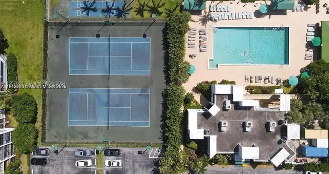 an aerial view of a house with a street