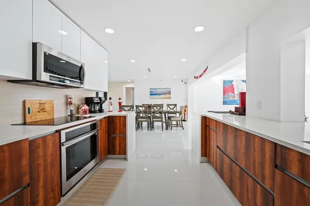 a kitchen with stainless steel appliances granite countertop a refrigerator and a stove top oven