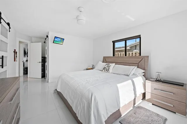 a bedroom with a bed and a painting on the wall