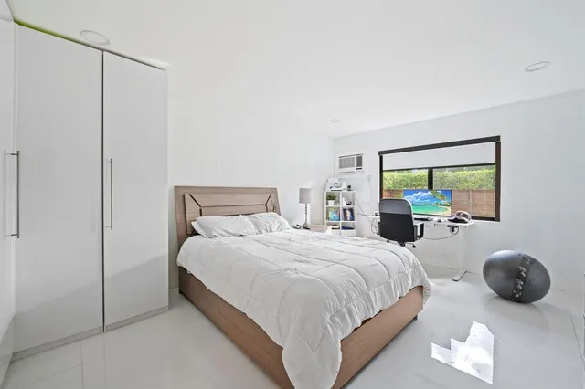 a bedroom with a bed and a couch