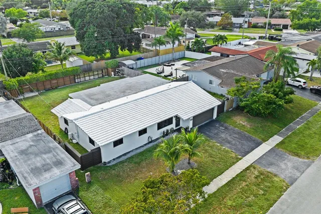 an aerial view of a house with swimming pool garden and patio