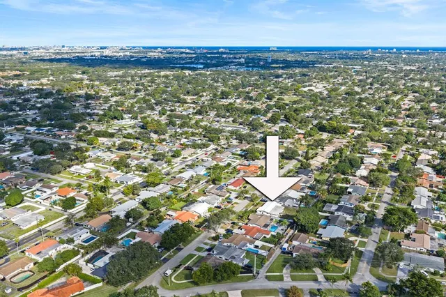 an aerial view of residential building with outdoor space and ocean view