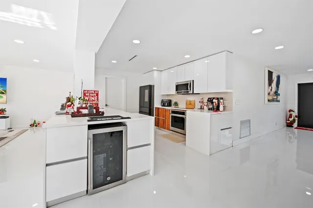 a kitchen with white cabinets and white appliances