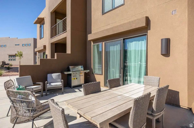 4846 Fishers Is Way St. George, UT 84770 - Photo 12 of 13 Private patio space featuring a sliding glass door entry, exterior wall sconce, and stucco exterior