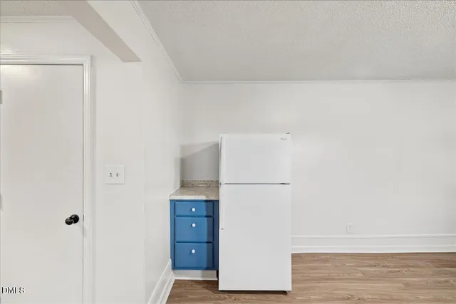 a view of kitchen and white refrigerator