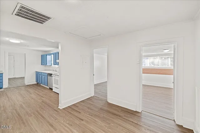 a view of a kitchen with wooden floor and a kitchen