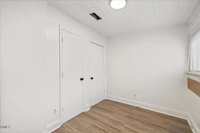 a view of washer and dryer with bathroom in the background