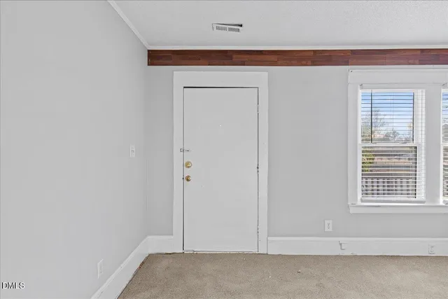 a view of empty room with fireplace