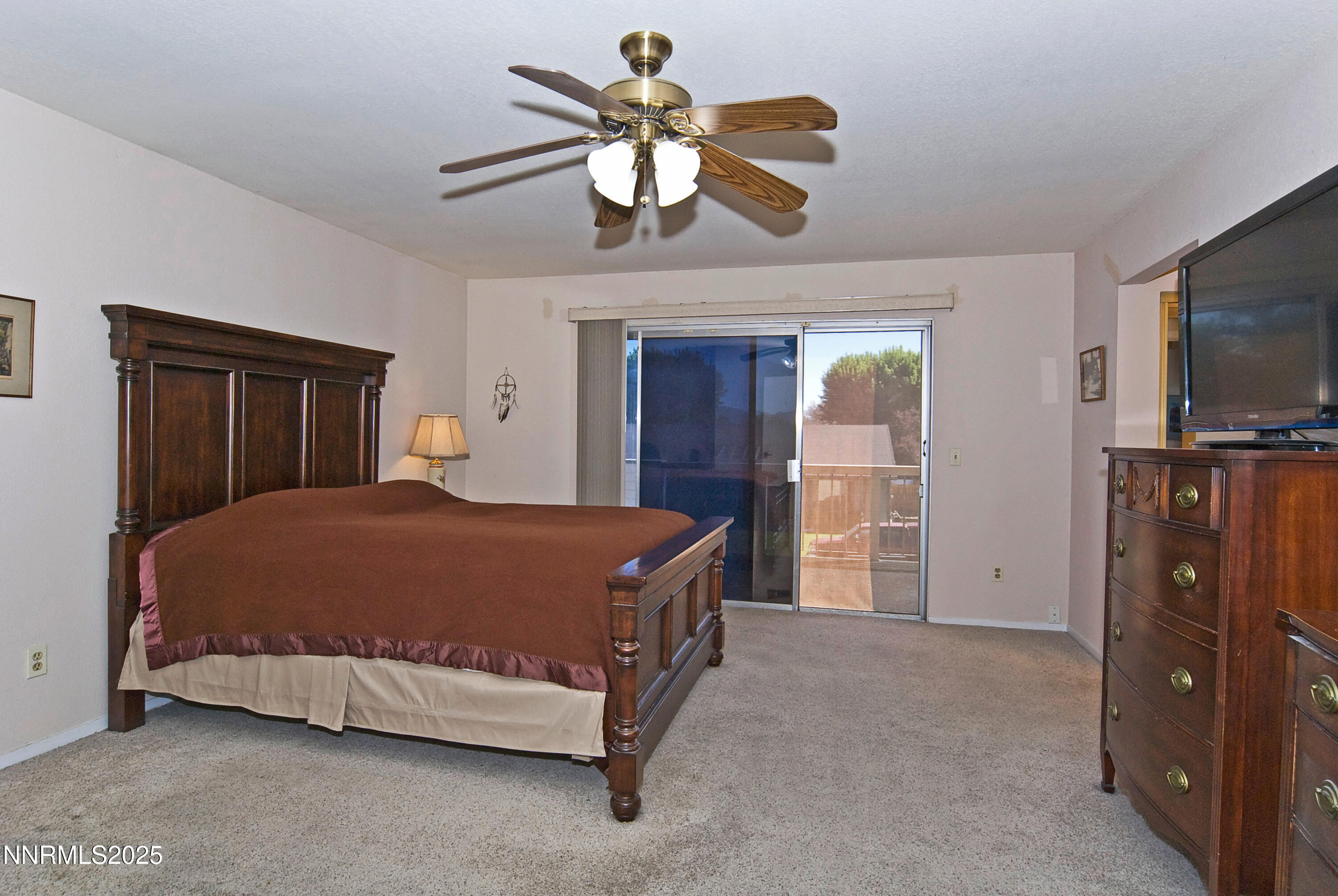 4875 Golden Springs Drive Reno, NV 89509 - Photo 19 of 33 a bedroom with a bed and a flat tv screen on dresser