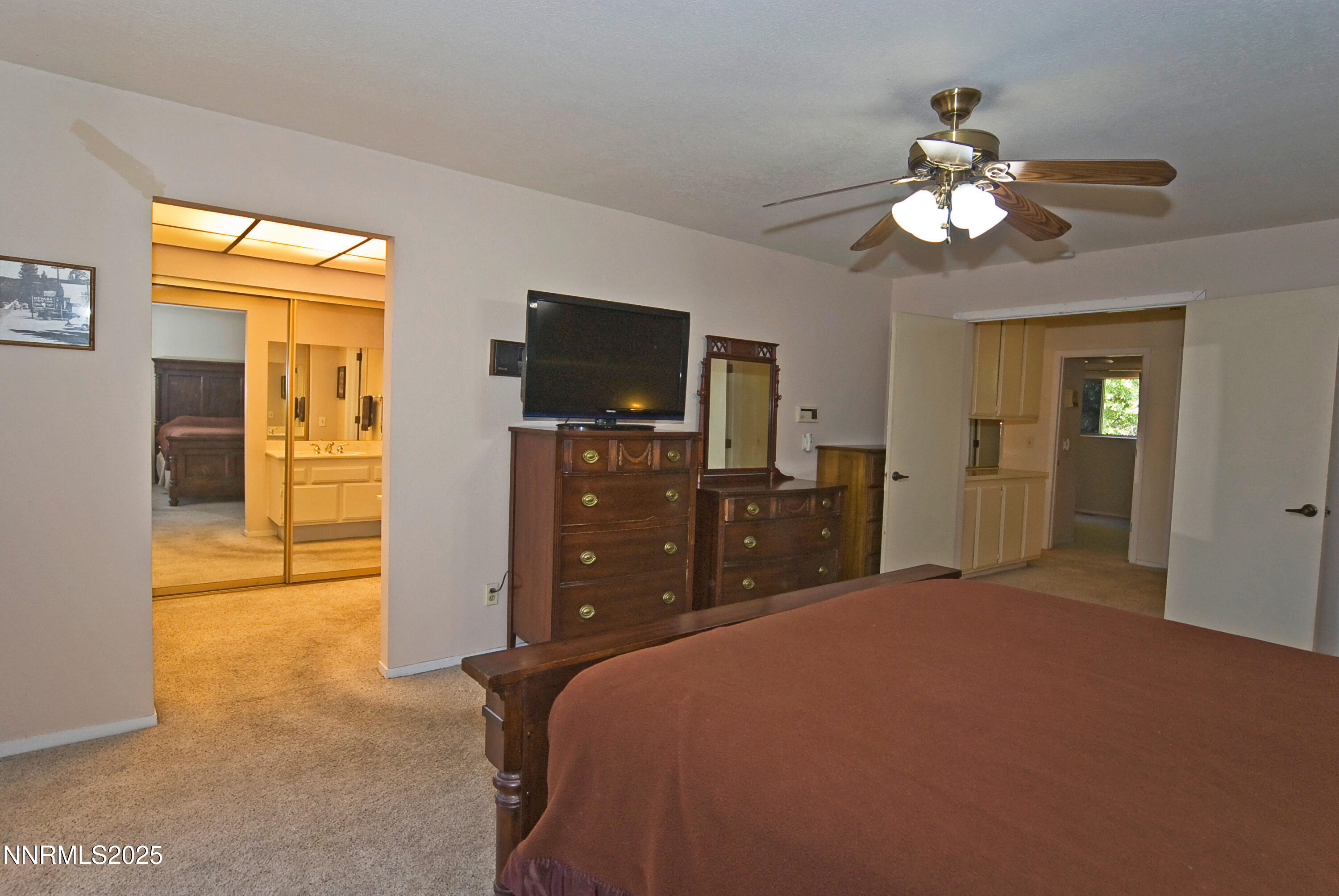 4875 Golden Springs Drive Reno, NV 89509 - Photo 21 of 33 a bedroom with a bed and a flat tv screen on dresser