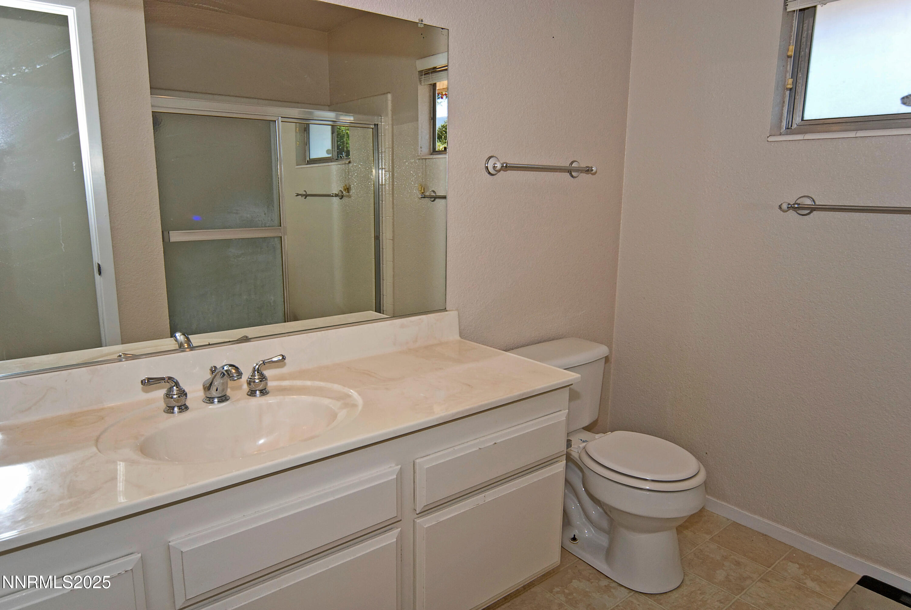 4875 Golden Springs Drive Reno, NV 89509 - Photo 27 of 33 a bathroom with a granite countertop sink a toilet and a mirror