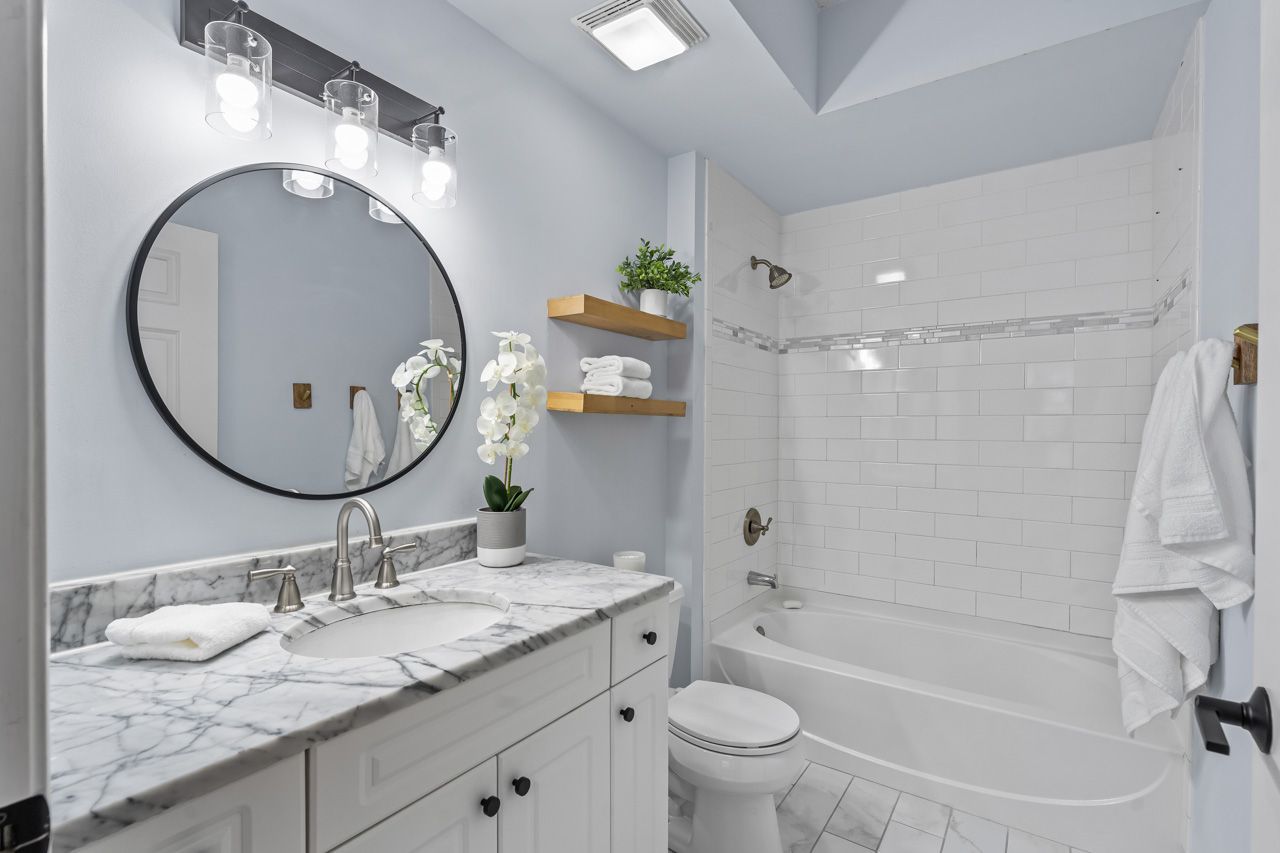 133 West Palatine Road, Unit 108 Palatine, IL 60067 - Photo 26 of 37 a bathroom with a granite countertop sink toilet and a mirror