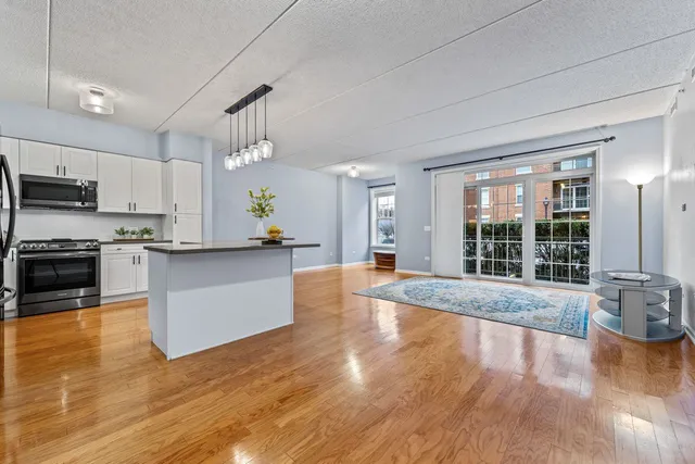 a large kitchen with kitchen island a large counter space a sink appliances and cabinets