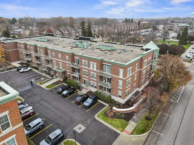 an aerial view of multiple houses with a yard