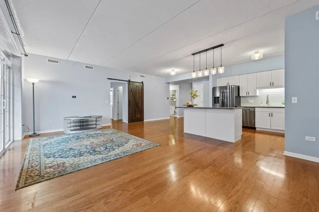 a view of kitchen and hall with wooden floor