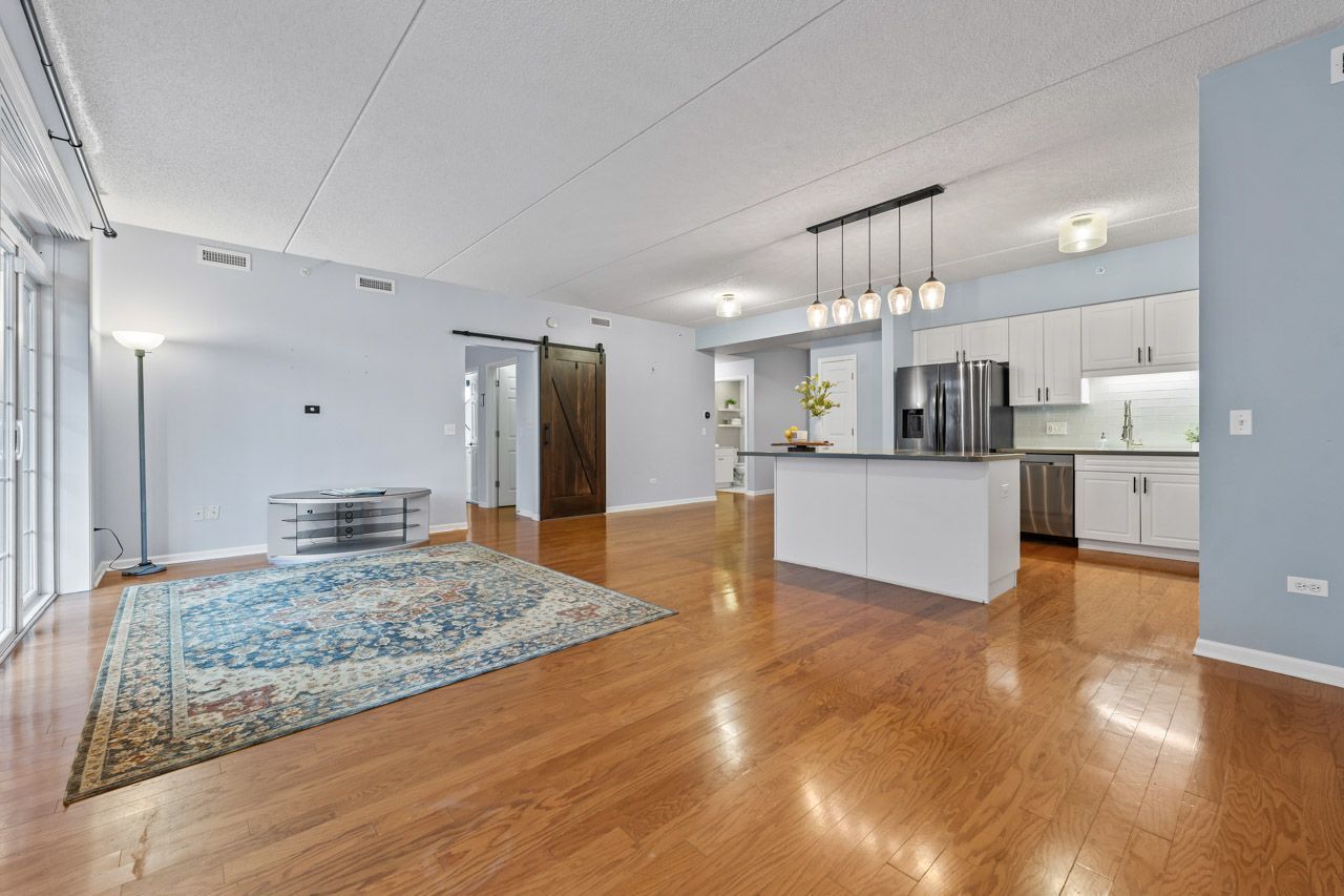 133 West Palatine Road, Unit 108 Palatine, IL 60067 - Photo 5 of 37 a view of kitchen and hall with wooden floor