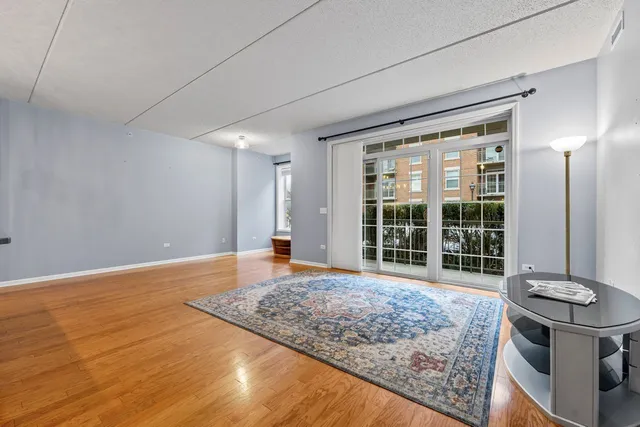 a view of a room with wooden floor and window